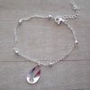 PULSERA DE ACERO BLANCO ESPEJITO CON BOLITAS Y DIJE CARACOL DE METAL. LARGO 16,5 CM + 4 CM EXT.