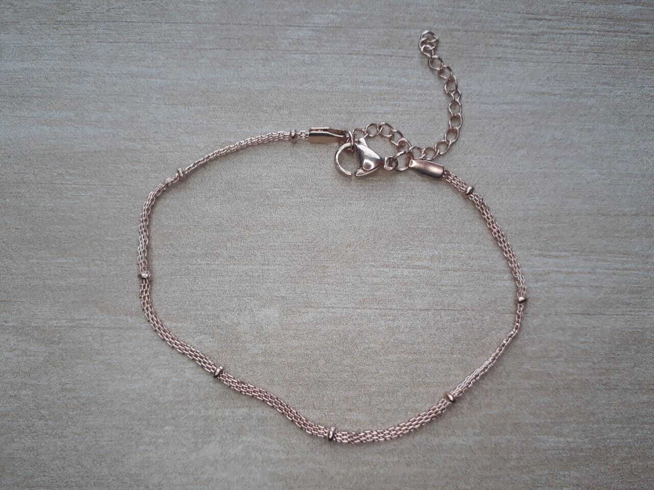 PULSERA DE ACERO DORADO ROSE MALLA PLANA CON BOLITAS. LARGO 17,5 + 4 CM EXT.