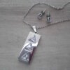 CONJUNTO DE ACERO CADENA ESPEJITO 0.4 CON DIJE RECTANGULAR CON TRES TRIÁNGULOS DE CUBIK Y ARO CUBIK 6 MM . LARGO CADENA 49 CM, DIJE 14 X 32 MM