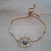 PULSERA DE ACERO DORADO VENECIANA AJUSTABLE CON DIJE OJO DE STRASS Y CENTRO AZUL