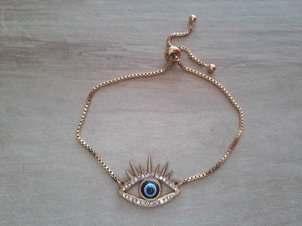 PULSERA DE ACERO DORADO VENECIANA AJUSTABLE CON DIJE OJO DE STRASS Y CENTRO AZUL