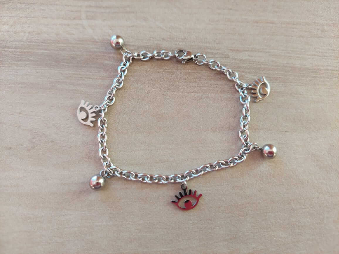 PULSERA DE ACERO ESLABÓN TIFFANY CON BOLITAS Y DIJES DE OJO TURCO. LARGO 18,5 CM
