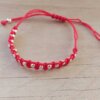 PULSERA TEJIDA DE HILO ROJO  AJUSTABLE CON BOLITAS DE ACERO BLANCO