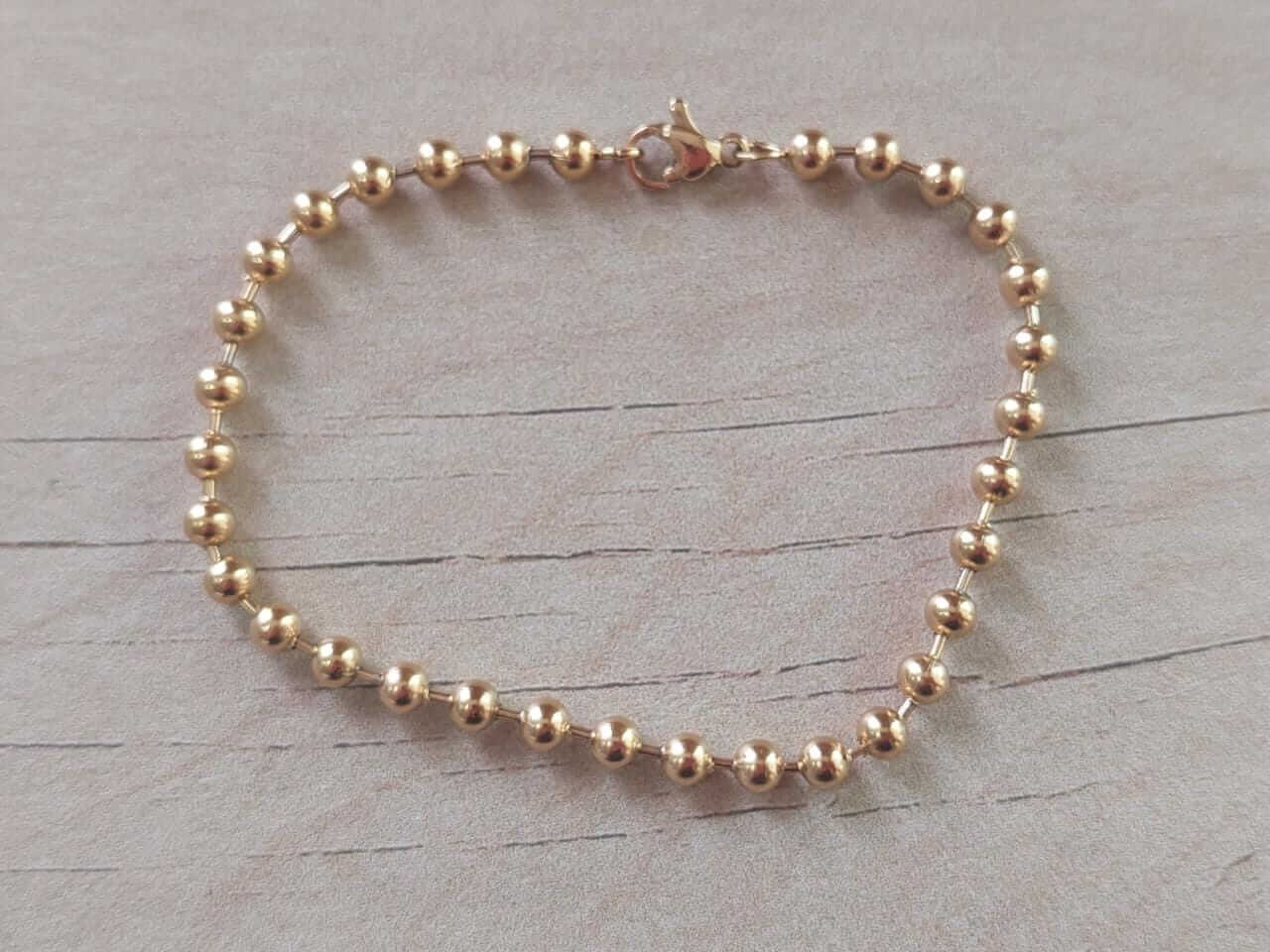 PULSERA DE ACERO DORADO ESLABÓN BOLITAS 4 MM. LARGO 19 CM