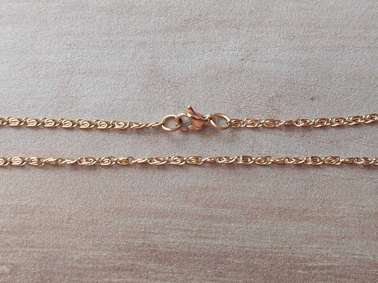 CADENA DE ACERO DORADO CARACOL 0.4