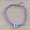 PULSERA DE TANZA CON MOSTACILLAS VIOLETA Y OJO TURCO CON TERMINAL DE ACERO. LARGO 18 + 3 CM EXT.