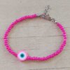 PULSERA DE TANZA CON MOSTACILLAS FUCSIA Y OJO TURCO CON TERMINAL DE ACERO. LARGO 18 + 3 CM EXT.