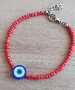 PULSERA DE TANZA CON MOSTACILLAS ROJAS Y OJO TURCO AZUL CON TERMINAL DE ACERO. LARGO 18 + 3 CM EXT.