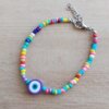 PULSERA DE TANZA CON MOSTACILLAS MULTICOLOR Y OJO TURCO CON TERMINAL DE ACERO. LARGO 18 + 3 CM EXT.