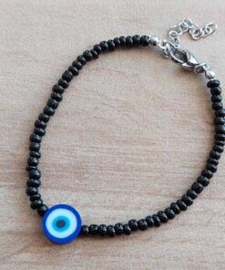 PULSERA DE TANZA CON MOSTACILLAS NEGRA Y OJO TURCO CON TERMINAL DE ACERO. LARGO 18 + 3 CM EXT.