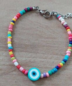 PULSERA DE TANZA CON MOSTACILLAS MULTICOLOR Y OJO TURCO CELESTE CON TERMINAL DE ACERO. LARGO 18 + 3 CM EXT.