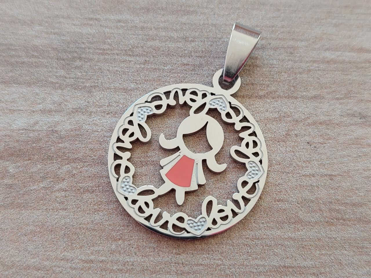 DIJE DE ACERO MEDALLA 25 MM CON NENA ESMALTADA ROSA INTERIOR Y BORDE "LOVE".