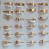 ANILLOS DE ACERO DORADO FLORES Y OJO TURCO X 36 UNIDADES SURTIDOS EN MEDIDAS. (MEDIDAS DEL 16 AL 21)