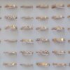 ANILLOS DE ACERO DORADO X 36 UNIDADES FIGURAS CON STRASS SURTIDOS EN MEDIDAS. (MEDIDAS DEL 16 AL 19)