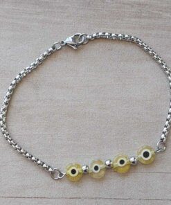 PULSERA DE ACERO ROLO CUADRADA CON OJITOS AMARILLOS Y BOLITAS INTERMEDIAS. LARGO 20 CM