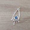 DIJE DE ACERO BLANCO LAGRIMA CALADA CON OJO TURCO INTERIOR. 12 X 30 MM