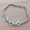 PULSERA DE ACERO DE BOLITAS 3 MM CON TRES OJITOS TURCOS DE NÁCAR EN EL CENTRO. LARGO 18 CM.