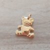 DIJE DE ACERO DORADO SILUETA OSITO EN RELIEVE. MEDIDAS APROX 20 MM .