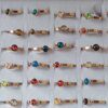 ANILLOS DE ACERO DORADO CON RESINA COLOR 6 MM Y DOS BOLITAS X 36 UNIDADES SURTIDOS EN MEDIDAS. (MEDIDAS DEL 16 AL 20)