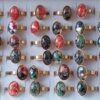 ANILLOS DE ACERO DORADO CON RESINA COLOR OVALADO X 36 UNIDADES SURTIDOS EN MEDIDAS. (MEDIDAS DEL 16 AL 21)