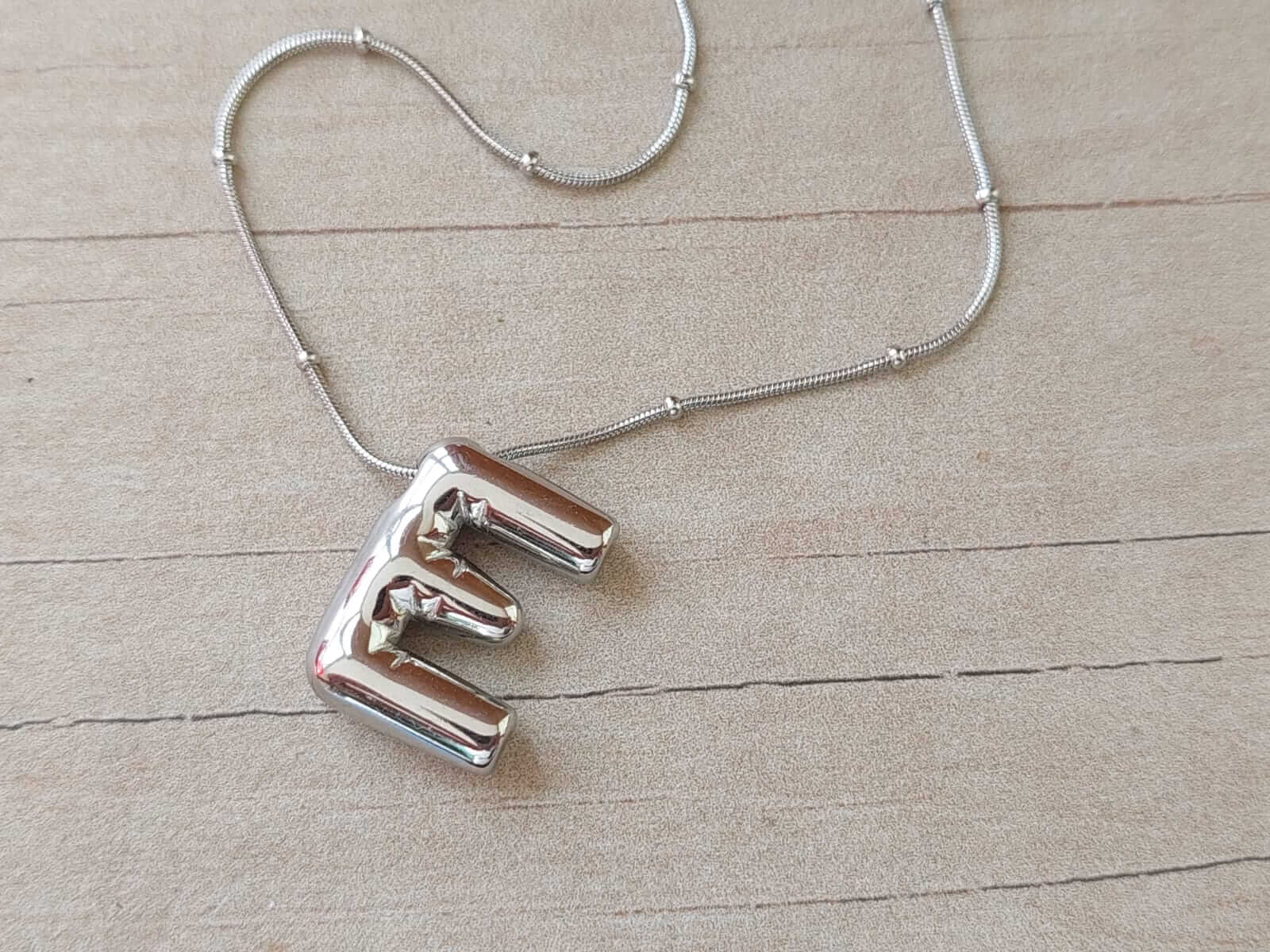 DIJE DE ACERO INICIAL E DE 15 X 20 MM CON CADENA CLAPTON CON BOLITAS DE 40 CM + EXT. DE 5 CM