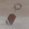 LLAVERO DE ACERO CON DIJE RECTANGULAR PARA GRABAR 28 X 47 MM PULIDO EN AMBAS CARAS. LARGO TOTAL 110 MM
