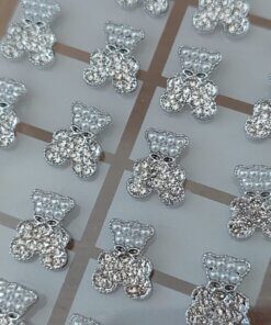 BLISTER DE AROS PASANTE DE ACERO OSO CON STRASS Y PERLITAS X 12 PARES.