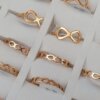 ANILLOS FIGURA INFINITOS CALADOS DE ACERO DORADO X 36 UNIDADES SURTIDOS EN MEDIDAS Y EN DOS MODELOS. MEDIDA DEL 16 AL 20.