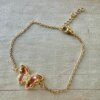 PULSERA DE ACERO DORADO ESLABÓN ESPEJITO CON MARIPOSA C/ STRASS Y ACRÍLICO CHAMPAGNE EN EL CENTRO. LARGO 17,5 + 2,5 CM EXT