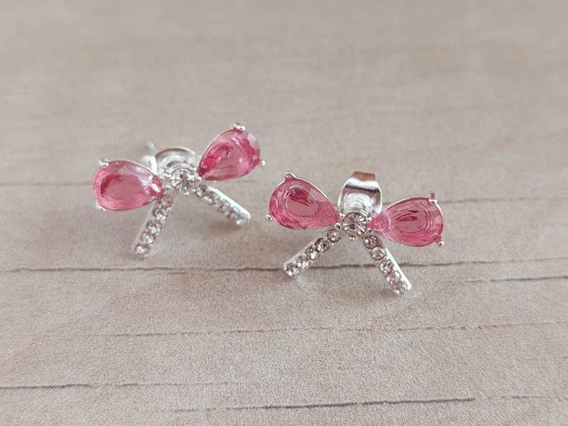 ARO DE ACERO BLANCO MOÑO CON STRASS Y CUBIK FUCSIA. MEDIDAS 18 X 11 MM