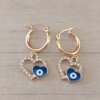 ARO DE ACERO DORADO ARGOLLA 14 MM CON DIJE CORAZÓN CON STRASS BLANCO Y OJO TURCO AZUL