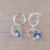 ARO DE ACERO BLANCO ARGOLLA 14 MM CON DIJE CORAZÓN CON STRASS BLANCO Y OJO TURCO AZUL