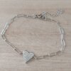PULSERA DE ACERO ESLABÓN ALARGADO CON CORAZÓN CON STRASS EN EL CENTRO. LARGO 19,5 CM + 5 CM EXT.