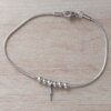 PULSERA DE ACERO COLA DE RATÓN CON BOLITAS Y DIJE RAYO. LARGO 18,5 CM