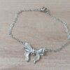 PULSERA DE ACERO ESPEJITO CON MOÑO EN EL CENTRO. LARGO 18,5 CM