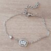 PULSERA DE ACERO ESPEJITO CON CENTRO STRASS RECTANGULAR CON STRASS ALREDEDOR Y SUSANITO. LARGO 15,5 CM + EST. DE 4 CM