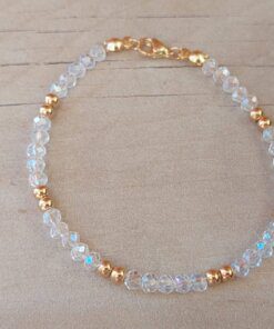 PULSERA DE TANZA CON MOSTACILLAS CRISTAL, DOS BOLITAS 3 MM INTERCALADAS Y TERMINAL DE ACERO DORADO. LARGO 18,5 CM.