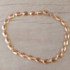 PULSERA DE ACERO ESLABÓN DORADO CONECTOR OVAL/SEMILLA. LARGO 18,5 CM