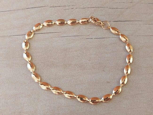 PULSERA DE ACERO ESLABÓN DORADO CONECTOR OVAL/SEMILLA. LARGO 18,5 CM