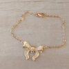 PULSERA DE ACERO DORADO ESLABÓN ESPEJITO CON CENTRO MOÑO. LARGO 18,5 CM