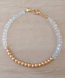PULSERA DE TANZA CON MOSTACILLAS CRISTAL, BOLITAS 3 MM CENTRALES Y TERMINAL DE ACERO DORADO. LARGO 18 CM.