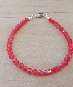 PULSERA DE TANZA CON MOSTACILLAS ROJO Y TERMINAL DE ACERO BLANCO. LARGO 18 CM.