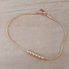 PULSERA DE ACERO DORADO ESLABÓN COLA DE RATÓN CON BOLITAS DE 3 MM CENTRALES. LARGO 19,5 CM