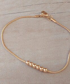 PULSERA DE ACERO DORADO ESLABÓN COLA DE RATÓN CON BOLITAS DE 3 MM CENTRALES. LARGO 19,5 CM