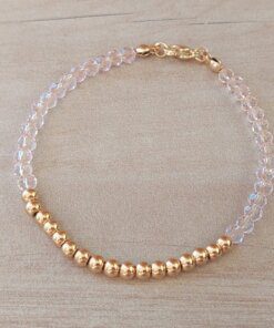 PULSERA DE TANZA CON MOSTACILLAS ROSA, BOLITAS 3 MM CENTRALES Y TERMINAL DE ACERO DORADO. LARGO 18 CM.