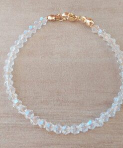 PULSERA DE TANZA CON MOSTACILLAS CRISTAL Y TERMINAL DE ACERO DORADO. LARGO 18 CM.