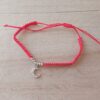 PULSERA DE HILO ROJO AJUSTABLE CON BOLITAS Y DIJE DE ACERO LUNA CON STRASS.