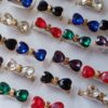ANILLOS DE ACERO DORADO MOÑO CORAZÓN DE STRASS X 36 UNIDADES.(MEDIDAS DEL 16 AL 19)