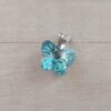 DIJE DE ACERO MARIPOSA DE ACRÍLICO CELESTE TORNASOL. 18 X 15 MM