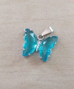 DIJE DE ACERO MARIPOSA DE ACRÍLICO CRISTAL TURQUESA. 15 X 20 MM